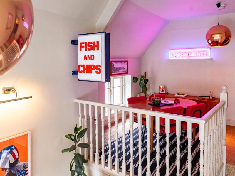 Retro dining area with "Fish and Chips" sign at The Loft by the Bay.