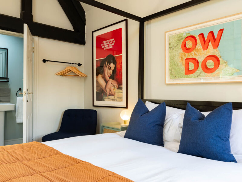Stylish bedroom with map art at Old Town House converted church holiday let.