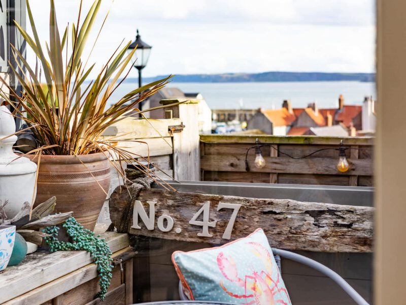 Harbour View House balcony with sea views and nautical decor.