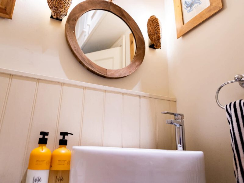 Modern bathroom sink and mirror at Harbour View House holiday let.