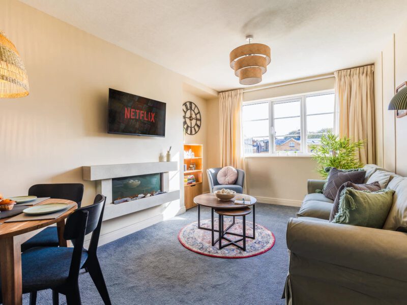 Penthouse Suite living area with dining table and modern fireplace.