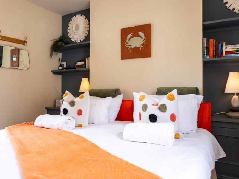Comfortable bedroom with sea-themed decor at Harbour View House.