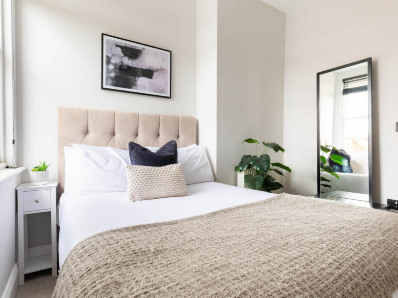 Comfortable bedroom with plush bedding at Ocean Pearl holiday let.