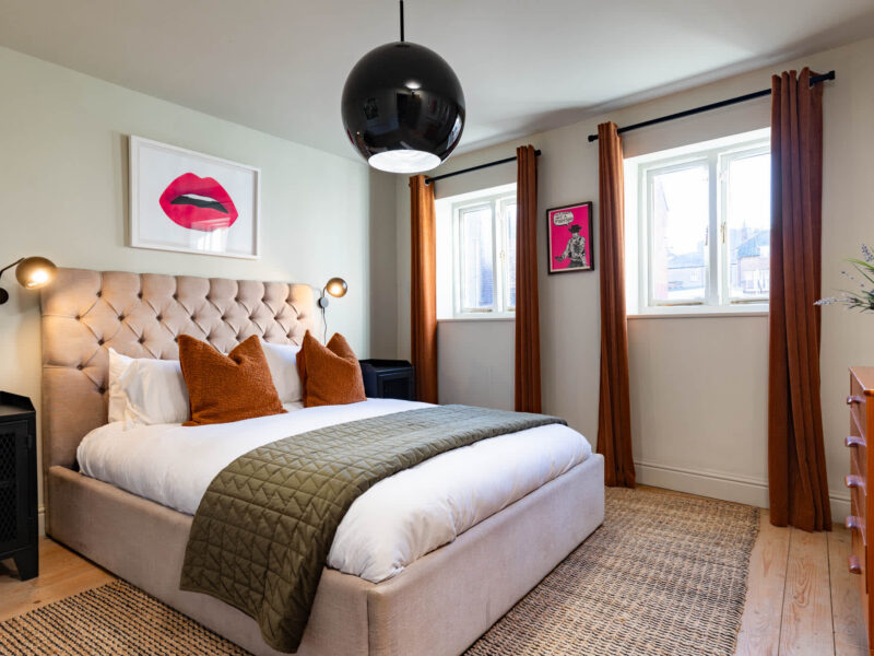 Stylish bedroom with modern art at Old Town House converted church rental.