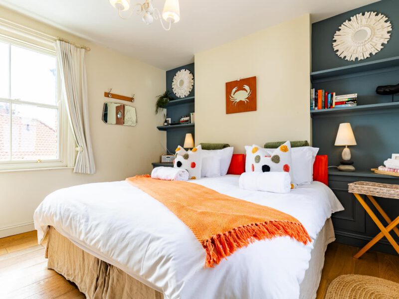 Coastal-themed bedroom with sea views at Harbour View House.