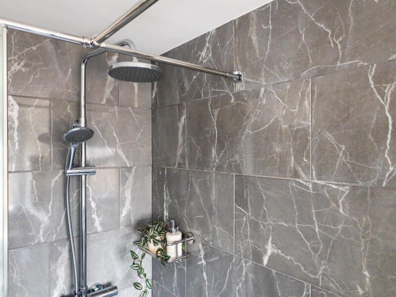 Modern marble shower in the Penthouse Suite, a quiet central escape.