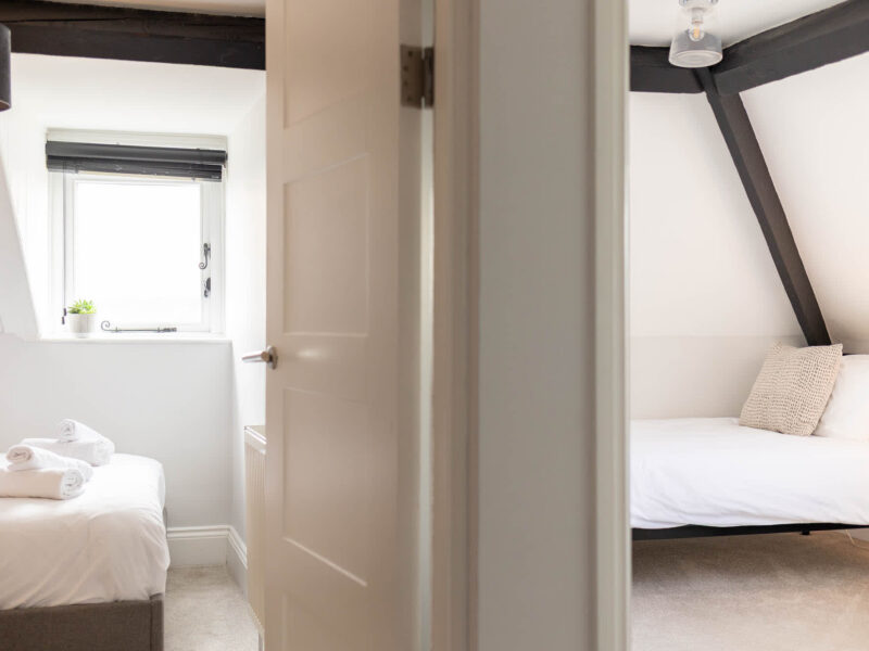 Ocean Pearl holiday let: twin beds and a double bed in bright rooms.
