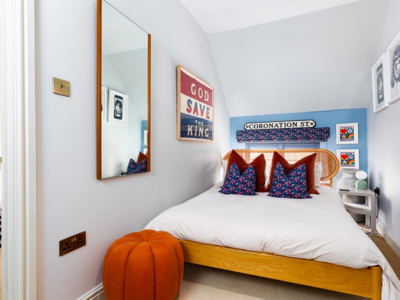 Stylish bedroom with Coronation St sign at The Loft by the Bay holiday let.