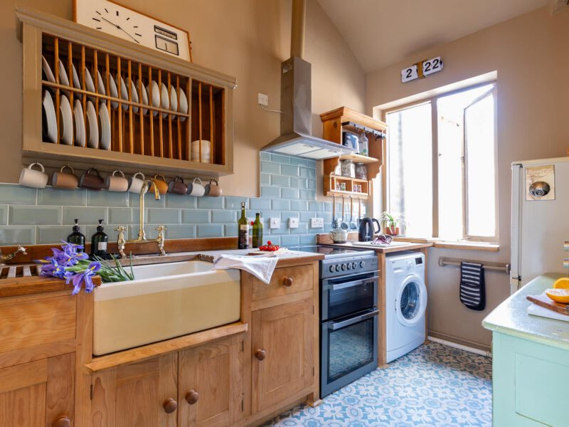 Stylish kitchen with farmhouse sink and dog-friendly amenities at The Loft by the Bay.