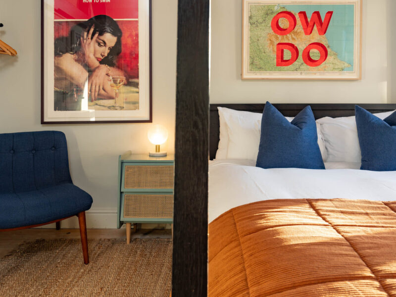 Stylish bedroom with vintage art and map at Old Town House converted church.