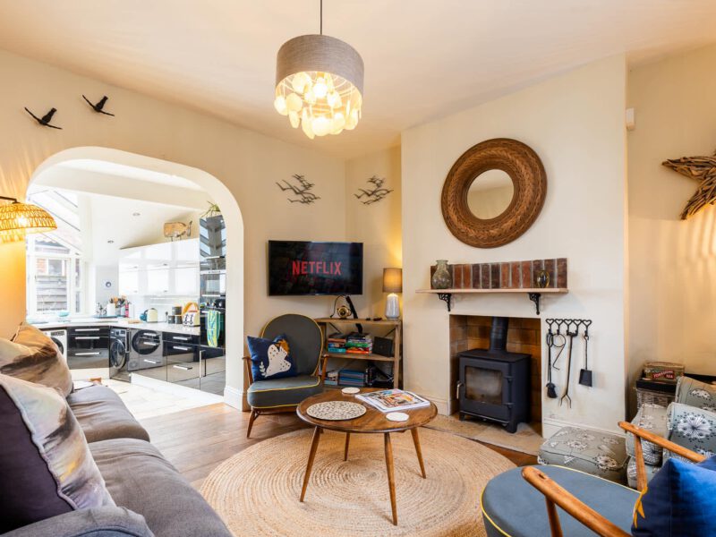 Cozy living room with wood burner at Harbour View House, Old Town.