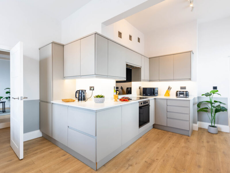 Modern kitchen with integrated appliances at Ocean Pearl holiday let.