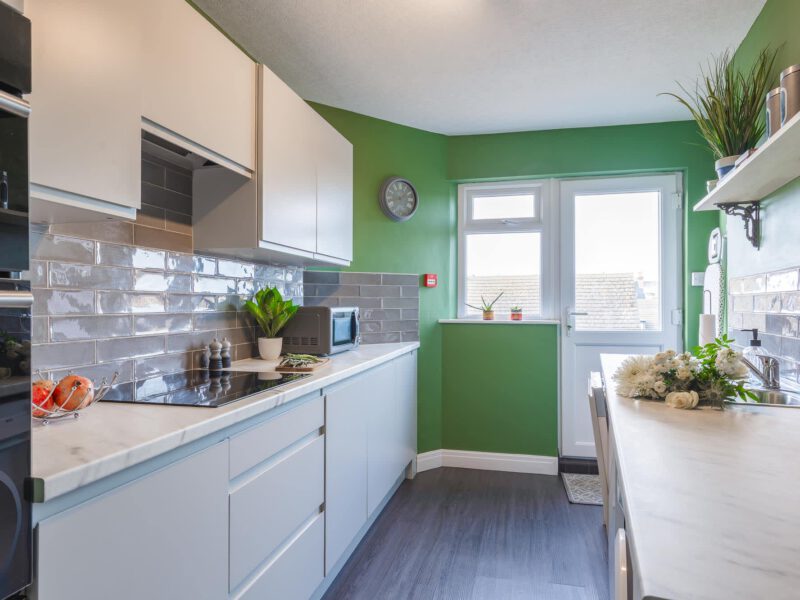 Modern kitchen with induction hob and marble countertops in Penthouse Suite.