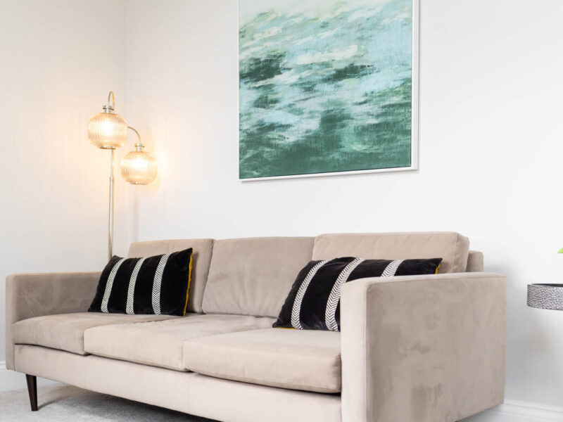 Stylish sofa with abstract art in Ocean Pearl holiday let.