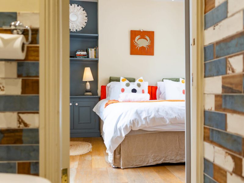 Coastal-themed bedroom with crab art at Harbour View House.