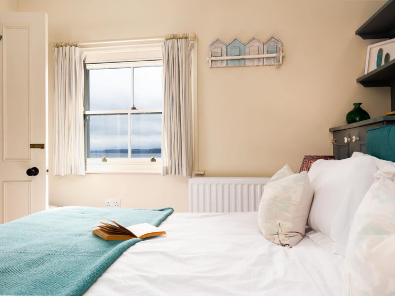 Comfortable bedroom with sea views at Harbour View House holiday let.