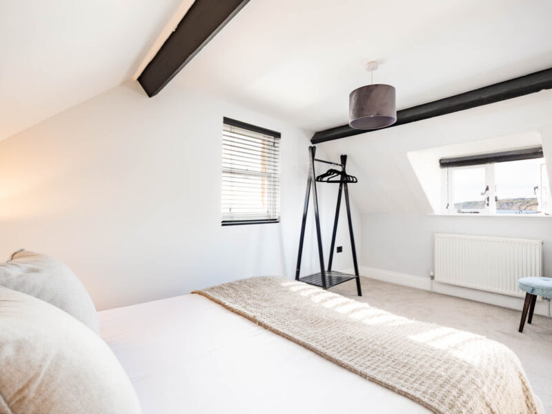 Ocean Pearl holiday let bedroom with sea views and exposed beams.