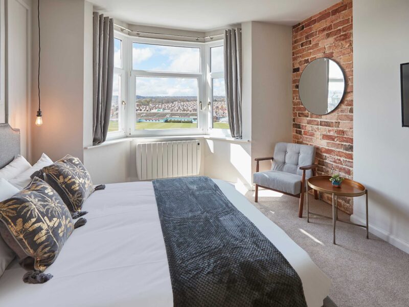 Bedroom with cricket ground view at Umpires Watch holiday let.