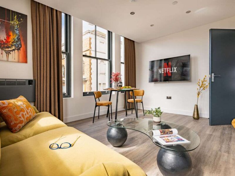 Albemarle Chambers: modern living area with Netflix TV and city views.