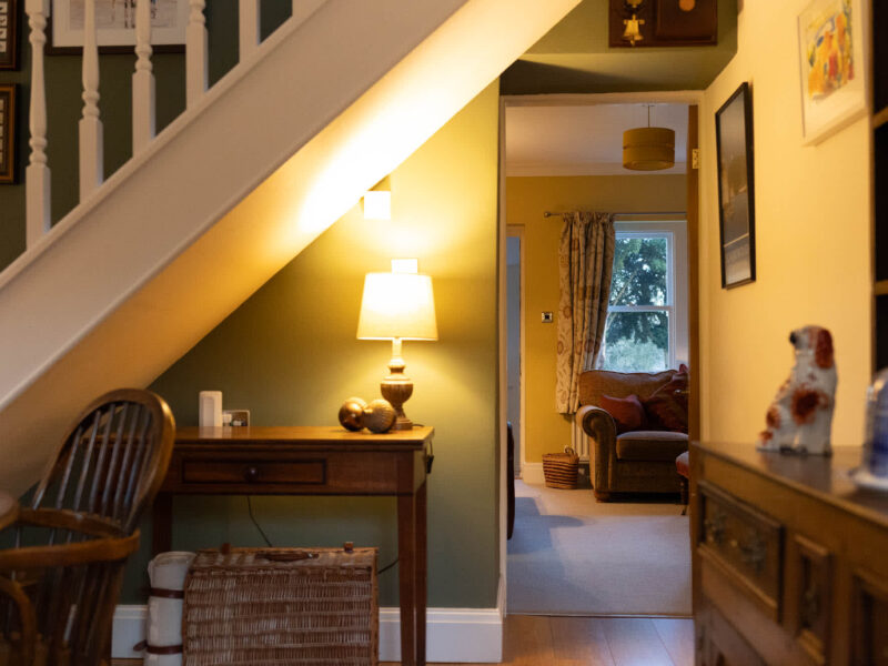 Interior hallway with staircase and view into living area at East Wing holiday let.