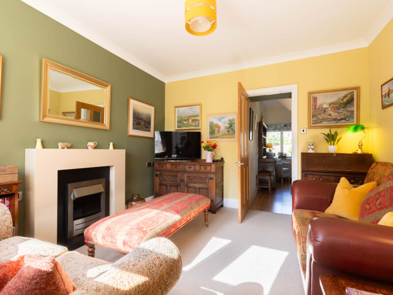 Cozy living room with fireplace and country views at East Wing holiday let.