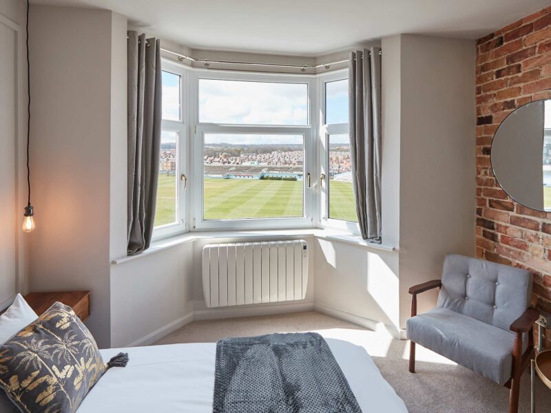 Cricket ground view from bedroom at Umpires Watch holiday let.
