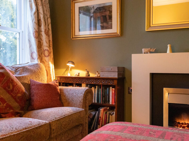 Cozy living area with fireplace and country views at East Wing holiday let.
