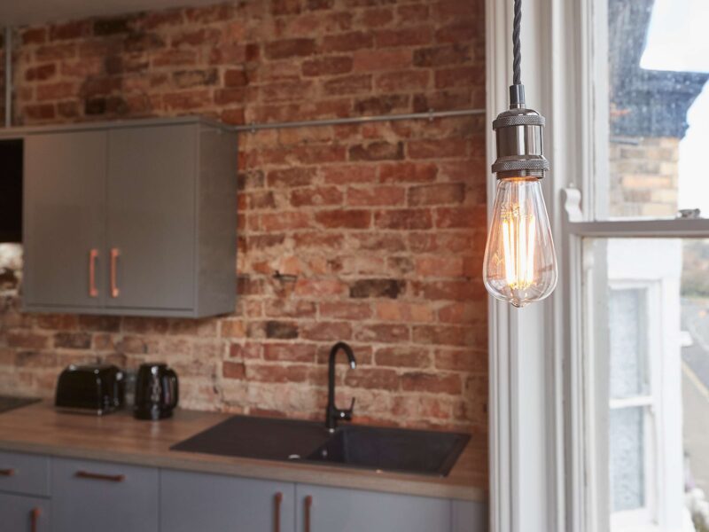 Modern kitchen with exposed brick at Umpires Watch, Cricket View.