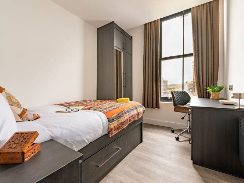 Albemarle Chambers: single bed, desk, and wardrobe in a central retreat apartment.