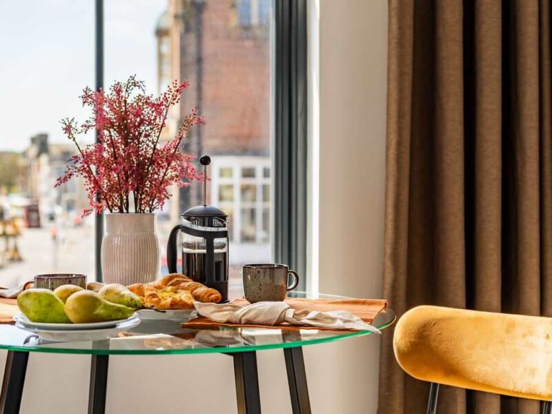 Breakfast spread with coffee and pastries at Albemarle Chambers central retreat.