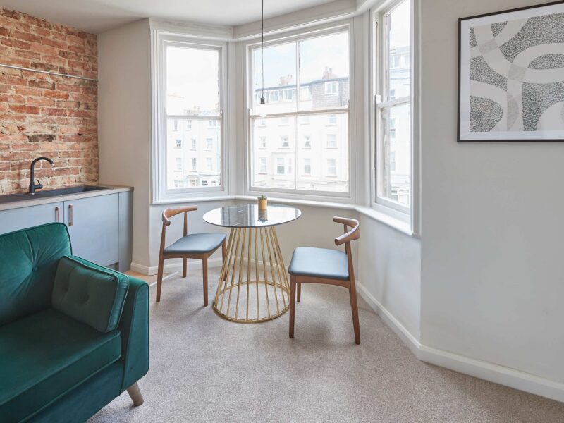 Dining area with bay windows at Umpires Watch Cricket View holiday let.