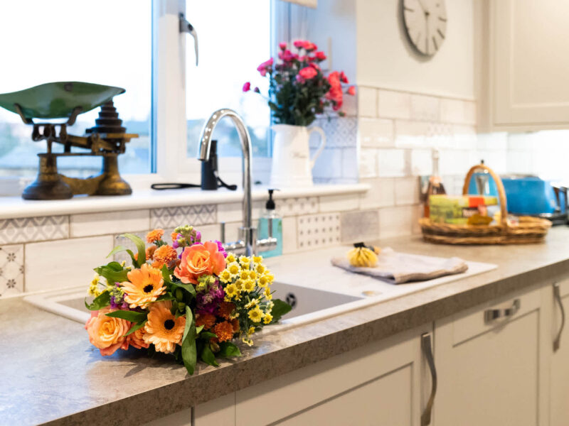 Fresh flowers on kitchen counter at East Wing holiday let.