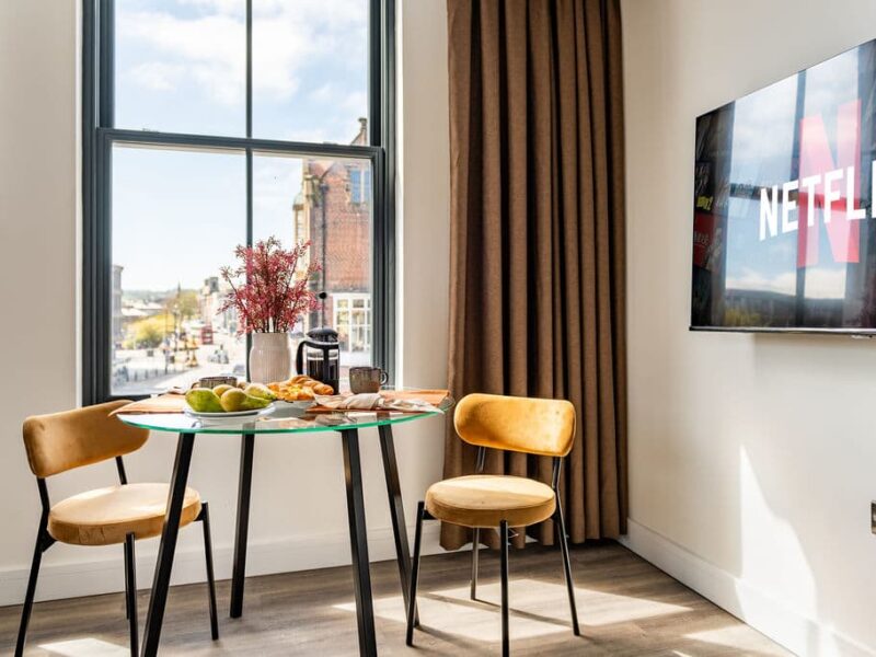 Dining area with city views at Albemarle Chambers, a central retreat.