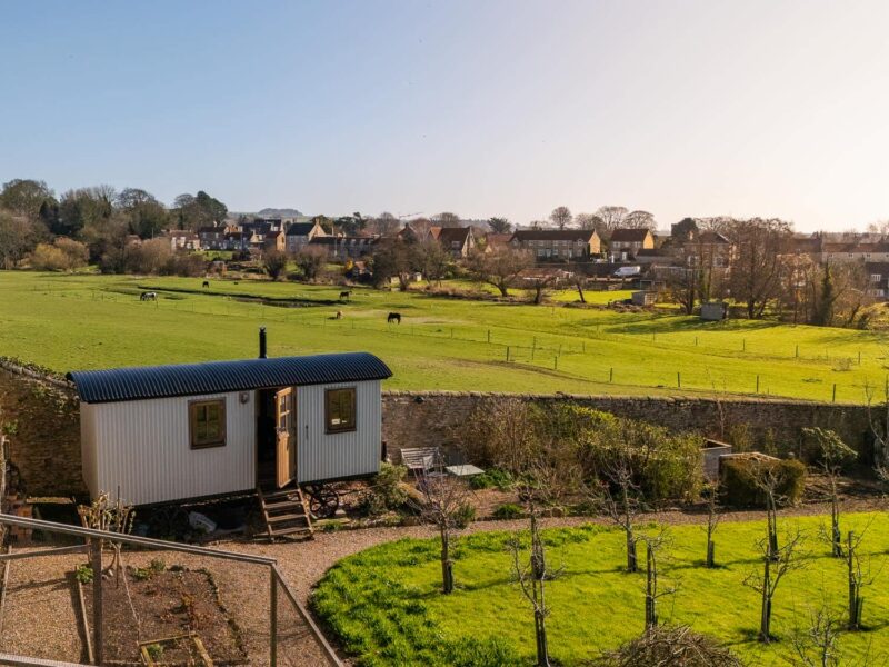 Plank Bridge shepherds hut nestled in an apple orchard with countryside views.
