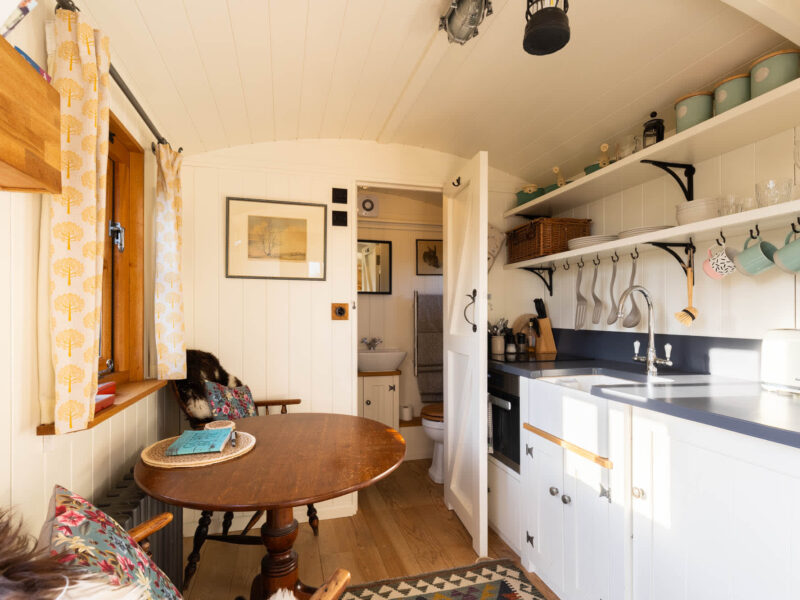 Cozy kitchen and dining area in Plank Bridge shepherds hut, sleeps 2.