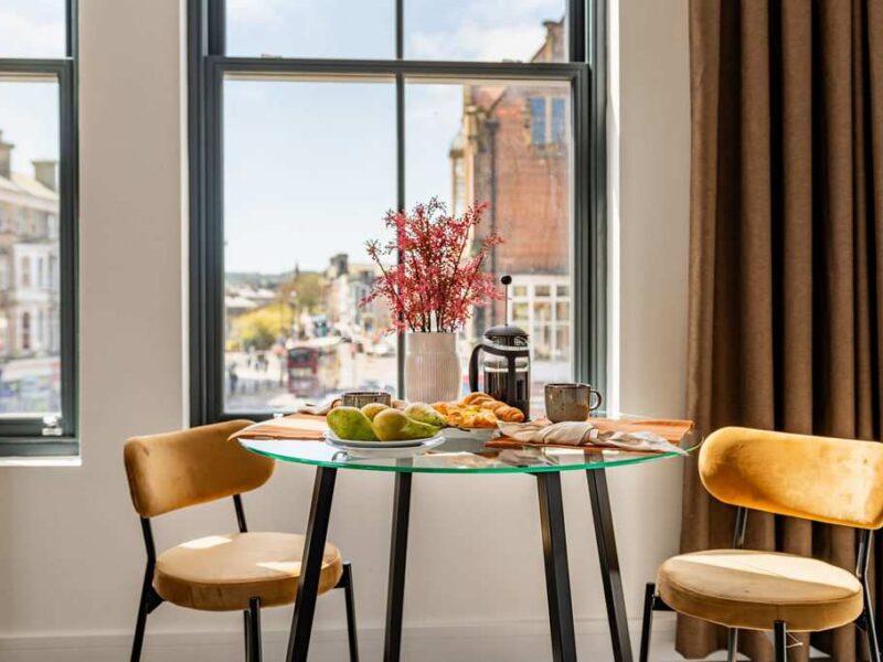 Breakfast table with city views at Albemarle Chambers central retreat.
