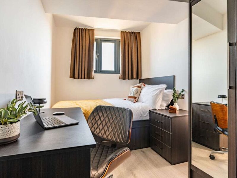 Desk and bed in Albemarle Chambers central retreat accommodation.