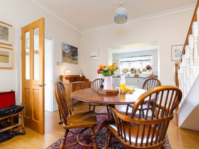 Dining area with wooden table and chairs at East Wing holiday let.