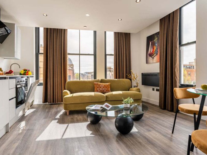 Albemarle Chambers: modern living area with kitchen and city views.