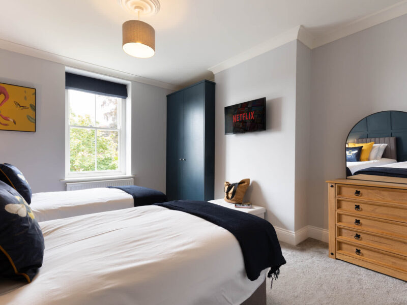 Twin beds in a stylish bedroom at Malton Luxury Retreat, sleeps 10.