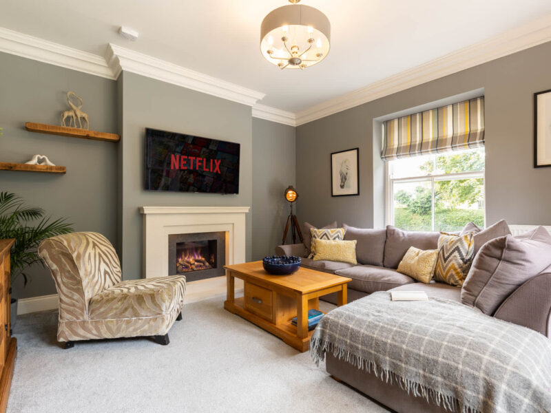 Luxury living room with fireplace and Netflix at Malton Retreat.