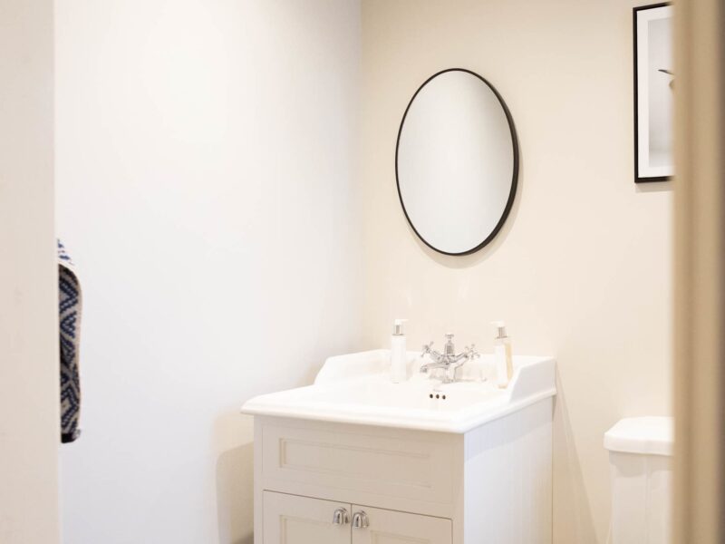 Malton Luxury Retreat bathroom with vanity, mirror, and toiletries.