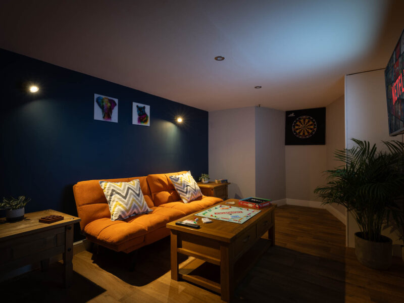 Malton Luxury Retreat living area with Monopoly and dartboard.