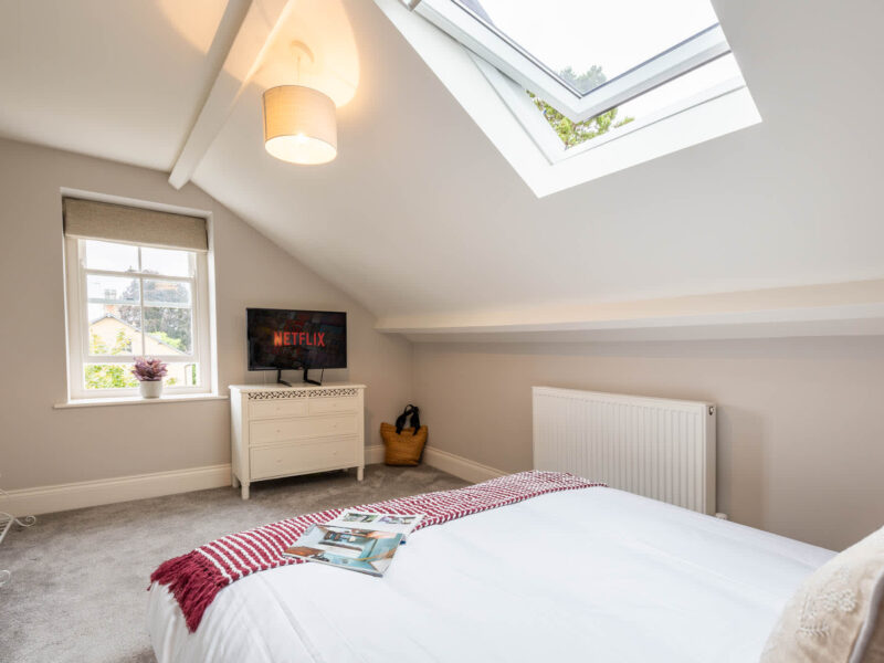 Cozy bedroom with skylight and Netflix TV at Malton Luxury Retreat.