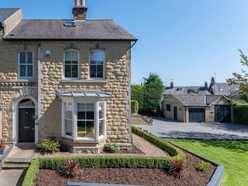 Malton Luxury Retreat: Stone facade, bay window, and manicured gardens.