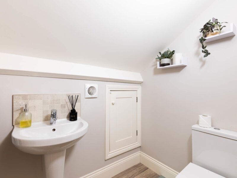 Modern bathroom with sink and toilet at Malton Luxury Retreat.
