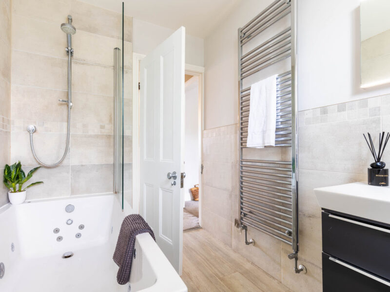 Luxury bathroom with jacuzzi tub and heated towel rail at Malton Retreat.