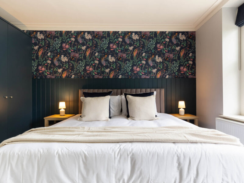 Luxurious bedroom with botanical wallpaper at Malton Luxury Retreat.