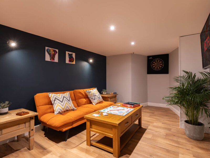 Malton Luxury Retreat living area with Monopoly and dartboard.